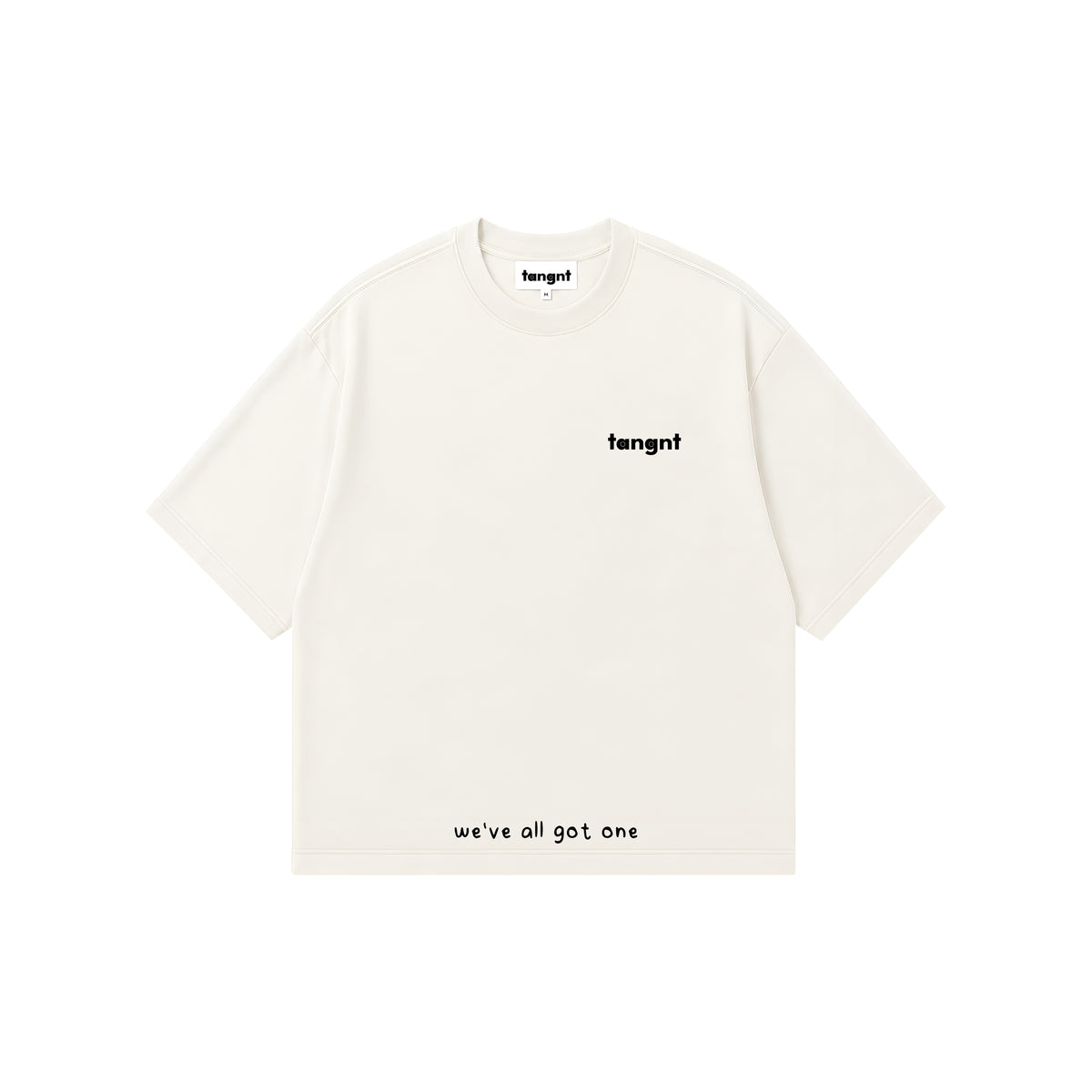 An off-white short-sleeve t-shirt with white text, featuring the brand name 'tangnt' on the left chest and 'we've all got one' printed near the bottom hem, displayed on a solid white background.